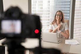 A corporate woman being recorded on camera for an interview