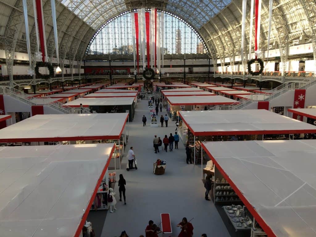 A physical trade show in progress with several booths in sight