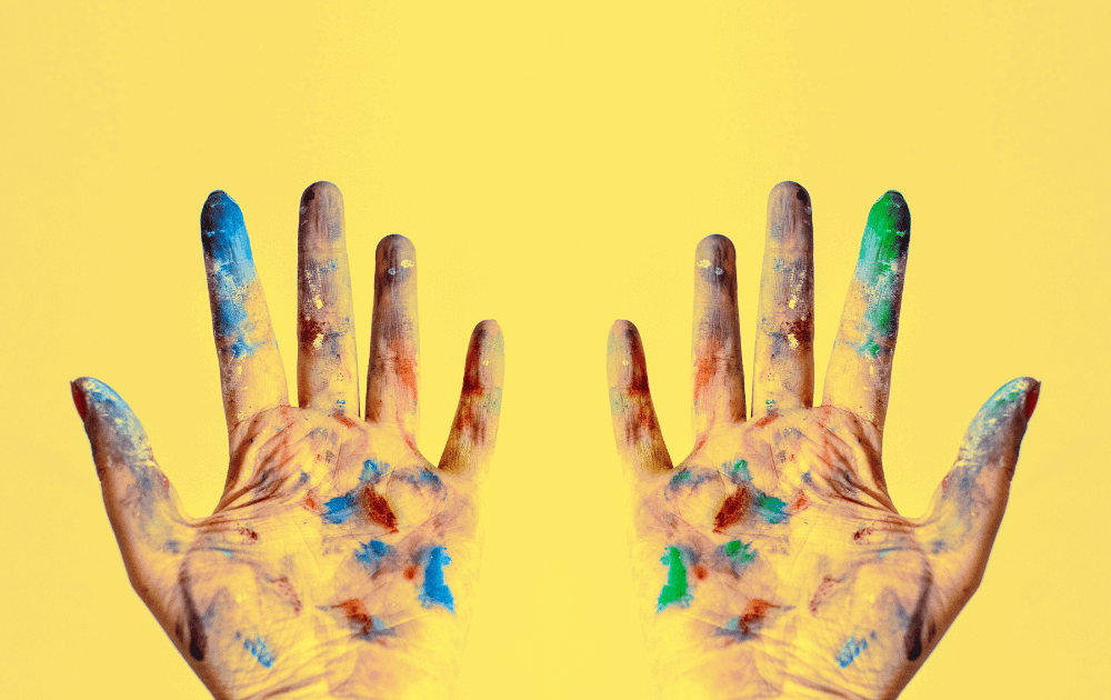 hands covered in paint 