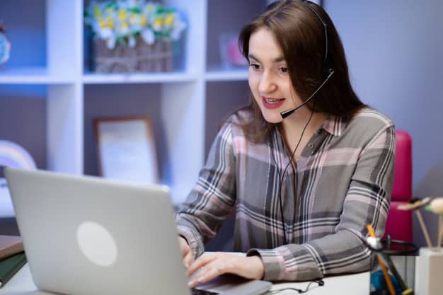 girl wearing headphones infront of laptop