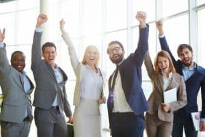 corporate team raising hands and celebrating success