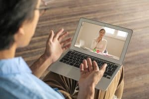 man having a video call with potential employer on a virtual job fair platform