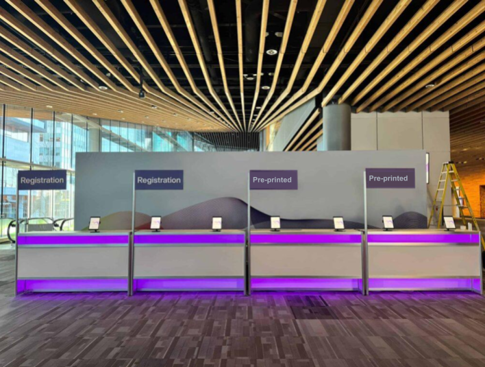 Separate desks for on-demand vs. pre-printed badges